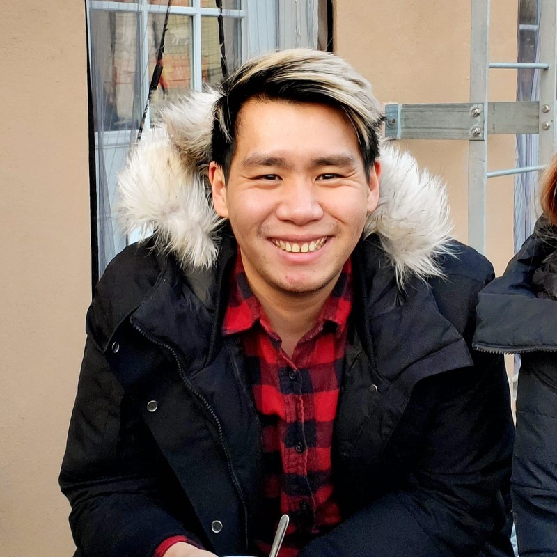 A picture of Leon, asian man with a checkered red shirt and short hair
