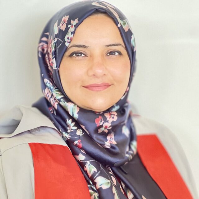 A headshot of Maryam, a South Asian woman wearing a dark headscarf and a graduation gown.